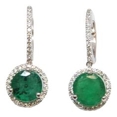 These gorgeous 2.91 ct round emerald & diamond earrings set in 18k white gold are sure to turn heads. Featuring 78 diamonds surrounding the 2 emeralds, they are definitely a great addition to any wardrobe. The diamonds boast a color of F/G and VS1 in clarity. Green Round Earrings With Diamond Accents, Hallmarked Round Emerald Earrings, Exquisite Green Round Earrings, Fine Jewelry Emerald Earrings, Round Shape, Green Emerald Multi-stone Earrings, Emerald Diamond Earrings, Metal Drop, Moonstone Earrings, Accessories Jewelry Earrings