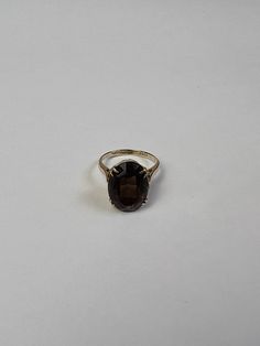 Beautiful English gold women's ring with a large, dark brown smoky quartz gemstone. The elegant ring is made of 375 9 carat gold. Ring size: 53 (approx. 17 mm inner diameter) Ring band: approx. 2 mm wide Ring crown: approx. 9 mm high Smoky quartz: approx. 1.5 cm x 1.2 cm (slightly crooked in the setting) Fineness: 375 9 carat gold Weight: approx. 4.25g This is tested real gold. All real gold rings can be enlarged or reduced in size by goldsmiths for little money. Classic 14k Gold Brown Ring, Classic Oval Brown Ring, Brown Gemstone Rings In 14k Gold, Classic Brown Oval Ring, Brown Oval Gemstone Rings, Elegant Brown Rings For Formal Occasions, Elegant Smoky Quartz Brown Rings, Formal Brown 14k Gold Rings, Classic Brown Hallmarked Rings