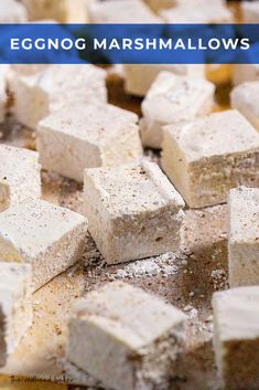 white marshmallows on a wooden table with the words eggnog marshmallows