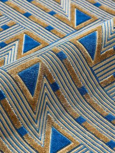 a blue and gold pattern on fabric