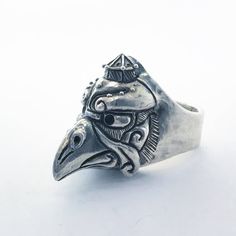 "Jewel made entirely by hand by the Italian artisan Gianmarco Fontana. This ring made of Silver 925 depicting Kerasu Tengu is part of the \"Japanized\" collection. The tengus take various forms, but generally they are represented as bird-men, endowed with a long prominent nose or even of beak, with wings on the head and often red hair; the less powerful ones, karasu tengu (烏 天狗?), kotengu (小 天狗?) or konohatengu (の 葉 天狗?) are portrayed as more similar to birds. The face may be red, green or black Ceremonial Symbolic Hand Cast Rings, Adjustable Symbolic Carved Rings, Unique Adjustable Ceremonial Rings, Unique Adjustable Rings For Ceremonial Occasions, Unique Carved Sterling Silver Rings, Artisan Carved Rings, Artisan Carved Adjustable Ring, Unique Sterling Silver Engraved Ring, Ceremonial Artisan Sterling Silver Rings