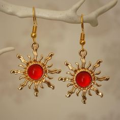 Make a statement with these pretty red sun drop earrings for women. These cool quirky gold plated and acrylic sun earrings are a great way to add a nice touch to your outfit. The charm on these sun dangle earrings measures at 3cm x 2.7cm and is attached to a gold plated hook. Please feel free to get in touch with us at Funky Earrings UK if you have any questions. We also have a wide range of other cute and unusual earrings in our shop. Crazy Earrings Gold, Red Gold Earrings, Gold And Red Earrings, Magician Outfit, Sun Earring, Fire Earrings, Earrings Cool, Cool Earrings, Cool Jewelry