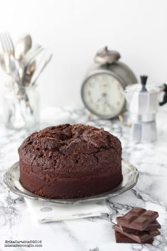 a chocolate cake sitting on top of a glass plate