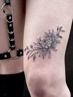 a woman's leg with a flower tattoo on it