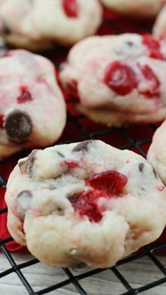 cookies with white chocolate chips and cherries on a cooling rack, ready to be eaten