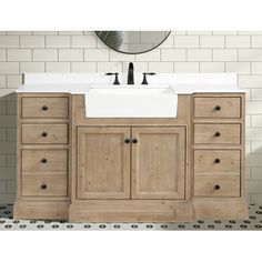 a white sink sitting under a mirror on top of a wooden cabinet next to a tiled wall