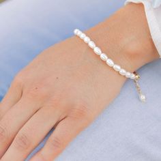 Dress up your wrist with this timeless white pearl beaded bracelet. Perfect for any special occasion, its simple yet elegant design adds a classic romantic touch to your outfit. With an adjustable chain, it fits comfortably any size wrist. Feel beautiful and sophisticated with this dainty and dreamy bracelet! ⬩3mm x4mm Natural Oval Freshwater Pearl⬩6-in bracelet with Gold Plated 2" chain for multiple closure options⬩Pearl is said to be associated with wisdom and romance This item will ship with Elegant White Pearl Bracelet With Adjustable Chain, Elegant Adjustable Beaded Bracelets With Pearl Drop, Elegant Beaded Bracelets With Pearl Drop, Feminine Pearl Drop Bracelets, White Pearl Bracelet With Adjustable Chain, Elegant White Beaded Bracelets With Adjustable Chain, Elegant White Beaded Bracelet With Adjustable Chain, Delicate Adjustable Pearl Bracelet, White Pearl Bracelets With Adjustable Chain