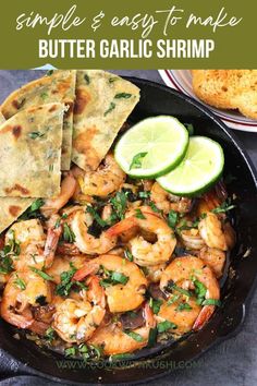 a skillet filled with shrimp and tortillas next to lime wedged pita bread