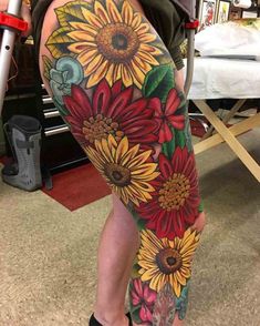 a woman's leg with sunflowers on it