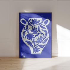 a blue and white vase sitting on top of a wooden floor next to a wall