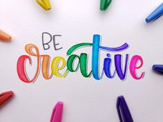 the words be creative written in colored crayons on a white paper surrounded by markers