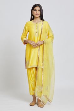 Yellow kurta with gota and aari work and buttoned placket. Paired with an embroidered pant and dupatta.
Components: 3
Pattern: Embroidered
Type Of Work: Gota, Aari
Neckline: Round
Sleeve Type: Three-quarter
Fabric: Kurta and Pant: Silk Chanderi, Dupatta: Organza
Color: Yellow
Other Details: 
Long
Occasion: Puja - Aza Fashions Yellow Kurta, Chanderi Dupatta, Types Of Work, Embroidered Pants, Kurta With Pants, Aari Work, Fashion App, Set For Women, Aza Fashion