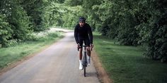 a man riding a bike down a dirt road