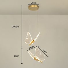 the measurements for a hanging light fixture in a room with white walls and flooring