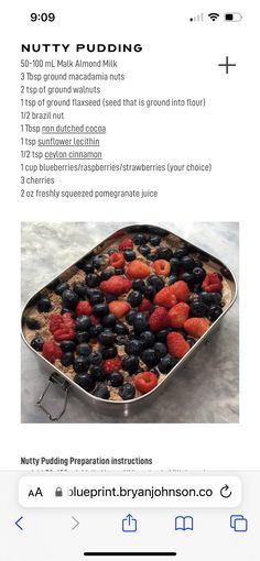 a pan filled with berries and blueberries on top of a table