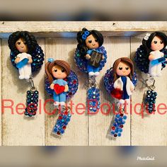 four little angel ornaments hanging on a wooden wall with the words red circle boutique above them