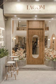 a store front with an open door and two stools in front of the entrance