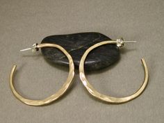 These gold filled hoop earrings are made from 12 gauge wire, so they're strong and have a lot of substance to them. They've  have been hand shaped and hammered individually, and then tumbled for strength and polished for a high shine. Sterling posts and ear nuts give it  that continuous flow and a secure fit to the ear lobe. A classic look that never goes out of style.  Made to order, so allow 10 working days for fabrication.  I always have some of these in stock, so check with me for available