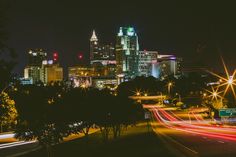 the city is lit up at night with bright lights on it's skyscrapers