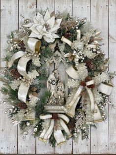 a wreath with white and gold decorations on it