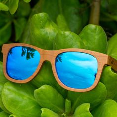 The Sunset Classic with Blue lens is inspired by the deep blue. With a lightweight design that floats on water this pair is sure to be your go-to sunglasses for all your beach days in Waikiki. The sunglasses feature an engraved tribal design on each arm and natural finished wood to promote durability. Product Details: Made from Cherry Wood Blue Mirror Polarized Lens UVA/UVB Protection Eco friendly sunglasses Unisex style Wayfarer Sunglasses With Mirrored Lenses For Vacation, Beach Wayfarer Sunglasses With Mirrored Lenses, Summer Polarized Sunglasses For Outdoor Activities, Wayfarer Sunglasses With Uv Protection For Beach, Uv Protection Wayfarer Sunglasses For Beach, Summer Outdoor Sunglasses With Polarized Lenses, Summer Mirrored Sunglasses For Outdoor Activities, Summer Wayfarer Sunglasses For Outdoor Activities, Trendy Blue Sunglasses For Outdoor Activities