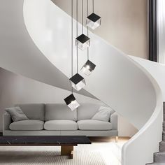 a white couch sitting under a stair case