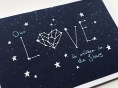 a card with the words love written on it and stars in the sky behind it