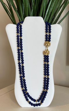 Kenneth Jay Lane's royal blue faux lapis beaded double strand necklace with double gold plated ram's heads encrusted with clear rhinestones and green rhinestone eyes. This was by designer Kenneth Jay Lane for Avon and in excellent condition. Please see pictures and video for description. Signed K.J.L. for Avon at clasp. Please visit my shop for more vintage jewelry: https://vintagetimejewelry.etsy.com/ Elegant Royal Blue Beaded Jewelry, Blue Beads Necklace, Ram Head, Rhinestone Eyes, Blue Beaded Necklace, Double Strand Necklace, Celebrity Design, Kenneth Jay Lane, Jewelry Business