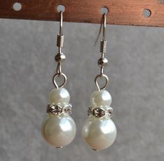 I make the earring to use 6-8mm glass pearls. IT is good earrings for your great wedding.If you need the other colour,Please let me know. I can make different type earrings to your requirements,Please feel free to contact me if you have any question. Thank you so much. . Matching bracelet: https://www.etsy.com/listing/155194595/ivory-pearl-braceletglass-pearl?ref=shop_home_active_3 6mm and 10mm pearls earrings matching this necklace: https://www.etsy.com/listing/155894841/white-pearl-necklacegla Elegant Round Beads Crystal Earrings For Wedding, Elegant Beaded Crystal Earrings For Wedding, Wedding Crystal Earrings With Round Beads, 10mm Pearl Earrings, Pearl Dangle Earrings Wedding, Dangling Pearl Earrings, Pearl Earrings Designs, Drop Jewelry, White Pearl Earrings