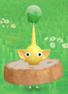 a yellow bird standing on top of a piece of wood in front of green grass and daisies