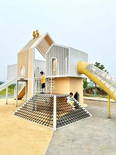 two children playing on a slide at a playground