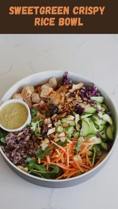 a white bowl filled with different types of salads and dressing on top of a table