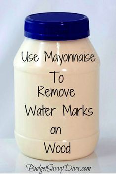 a white jar with blue lid that says use mayonnaise to remove water marks on wood