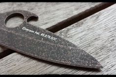 a large knife sitting on top of a wooden table