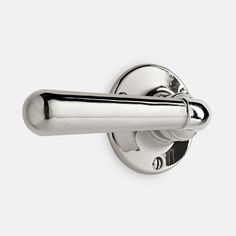 a chrome door handle on a white wall