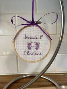 a cross stitch ornament hanging from a hook