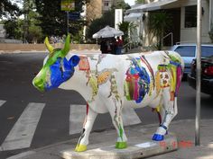 a statue of a cow on the street