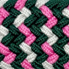 a close up view of a pink, white and green crochet afghan pattern