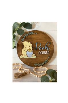 a wooden sign that says pooh corner with an image of a baby elephant on it