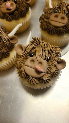 cupcakes decorated like animals are sitting on a table