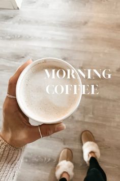 a person holding a cup of coffee with the words morning coffee on it in front of them