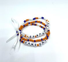 This listing is for a set of 3 beaded stretch bracelets that are tied together with a white ribbon. Perfect for Denver Bronco fans! Team-colored Wristband For Game Day, Denver Broncos Football Made With Seed Beads, Multicolor Team Spirit Beaded Bracelets For Game Day, Team-colored Letter Beads Bracelets For Sports, Broncos Bracelet, Go Broncos, Broncos Fans, White Ribbon, Beaded Stretch Bracelet