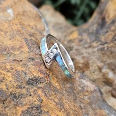 This beautiful Sterling Silver Ring, as part of the Amazing Light Collection, features Amazonite and Lab Opal. Includes 3 Cubic Zirconia. Ring Width: Top 3/8"; Shank 1/8" The ring is designed by David Rosales, one of the finest contemporary Southwest Artists in the world. He is the founder and co-owner of Supersmiths, Inc. of Gallup, NM. Each ring is custom made and carries a lifetime guarantee. Buffalo Jewelry, Contemporary Southwest, Spiny Oyster Jewelry, Lapis Jewelry, Black Arrow, Silver Belt Buckle, Silver Belts, Cabochon Ring, Silver Pendants