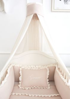 a bed with a canopy over it and two pillows