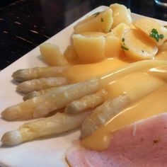 ham, potatoes and gravy on a white plate