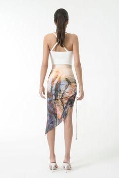 Cupro high waist skirt with diagonal hem. One gathered side with tie drawstring. Color: golden hour print. Shell: 55% Cupro; 45% Ecovero Viscose Made in Georgia This particular piece is non-returnable and non-exchangeable. Summer Ruched Skirt With Asymmetrical Hem, Summer Asymmetrical Hem Draped Skirt, Summer Asymmetrical Skirt With Tie Waist, Summer Party Wrap Skirt With Tie Waist, Summer Party Skirt With Tie Waist, Elegant Draped Skirt With Ruched Sides For Summer, Chic Summer Skirt With Side Ties, Asymmetrical Ruched Draped Skirt For Summer, Ruched Asymmetrical Draped Skirt For Summer