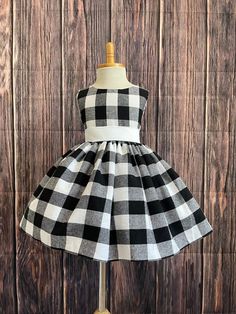 Little Darln Boutique Black & White Plaid dress that's perfect for any occasion: Christmas, photoshoot, wedding, birthday & More! This dress is made out of a comfortable cotton plaid. Bodice consists of a White satin sowed in sash (not removable) followed by plaid fabric that can be used to tie together into a bow at the back of the dress for a snug fit, followed with a hidden zipper. The plaid skirt has a layer on lining with crinoline attached to give the skirt some fullness. Petticoat is used to show full detail (NOT INCLUDED) Can be purchased separately! https://www.etsy.com/listing/1316417982/white-knee-length-petticoat-wedding?click_key=6abc7feb8e0e762dcafc93039a38eb4d928dfc29%3A1316417982&click_sum=70e051d8&ref=shop_home_active_1 Visit our store, more items to come!  https://www.ets Black And White Plaid Dress, Country Cow, Photoshoot Wedding, Puffy Dresses, Summer Christmas, Birthday Girl Dress, Wedding Summer, Christmas Photoshoot, Cow Girl