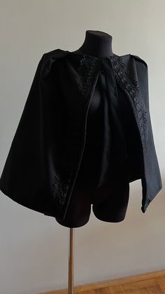 Black Wool Cape with Lace, Wool Capelet with Lace, Spring Cape, Black Cape Length 60 cm (23.62 inches) care instructions   Gently brush the coat with a soft suede brush. ... Hang wool coats on plastic or wood hangers between use. ... Blot spills on wool immediately to sop up moisture. ... Take wool coats to a dry cleaner twice a year. ... Store coats after the season in a garment bag. this fabric can be washed at home if done properly (hand washing). The three essential elements needed to succes Black Cape For Party, Black Outerwear For Costume, Black Costume Outerwear, Black Cape For Formal Occasions, Black Cape For Evening Wear, Elegant Black Cape For Costume, Black Fitted Cape For Formal Occasions, Black Evening Cape, Formal Fitted Black Cape