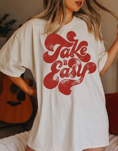 Take it easy in a dark yam color font on a white tee shirt as shown. You may change the color of the tee with the color chart provided! This is a high quality bo ho tee that is 100% ringspun cotton, and 99% preshrunk. It is oversized so you can order your size and it will fit like your boyfriends worn in vintage tee. Size up a size for oversized relaxed fit, or go up 2 sizes for the t shirt dress wear around the house by itself tee. They are sooooo comfy and soft it will become your favorite tee T Shirt Fonts, Pawsitive Vibes, Bo Ho, White Tee Shirt, Side Bar, Big Tshirt, Monkey Art, Hippie Shirt, Dance Shirts