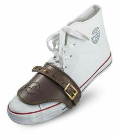 a pair of white shoes with brown straps on the bottom and one shoe has a gold buckle